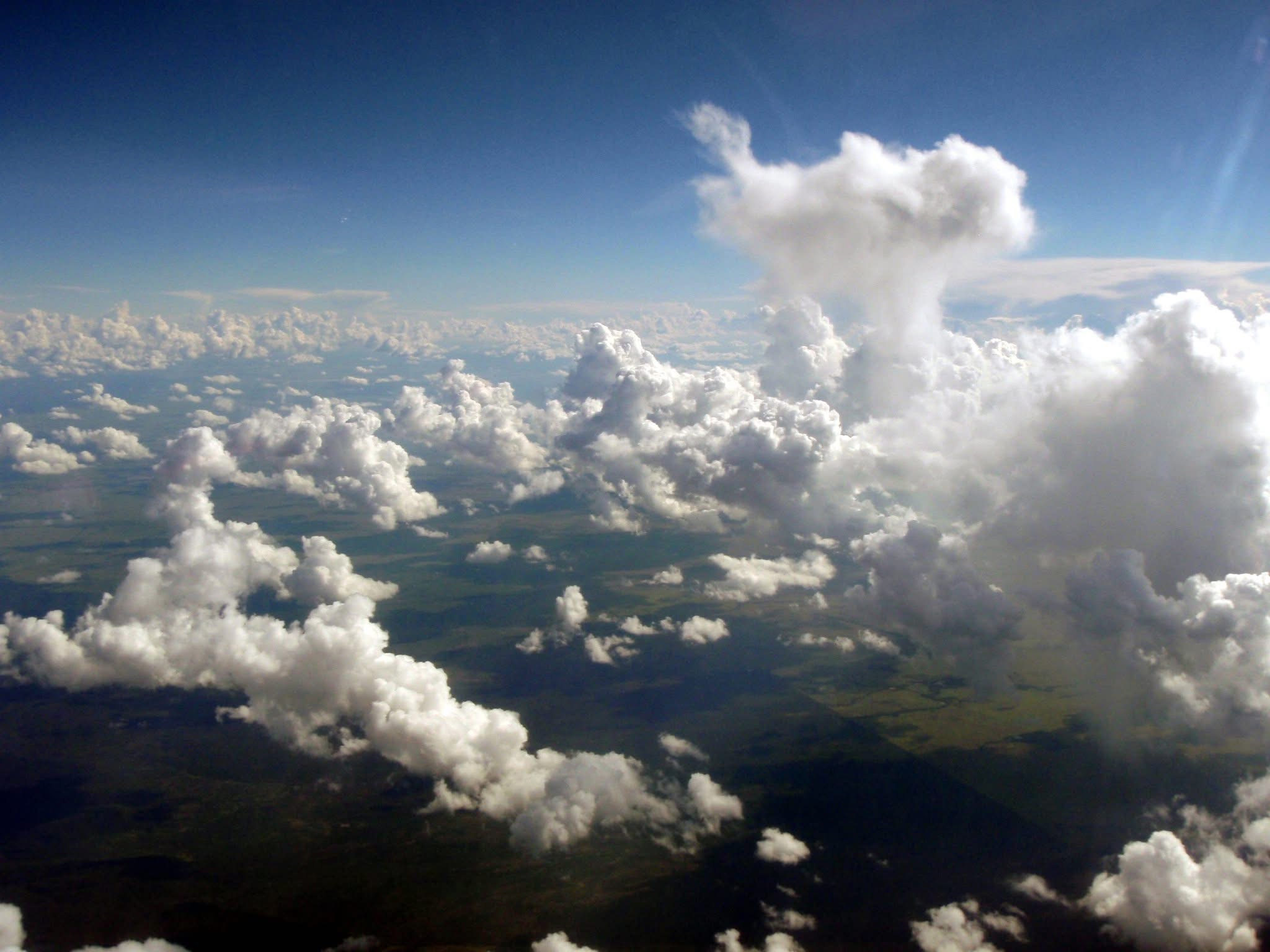 Towering cumulus clouds seen from an aircraft over the countryside