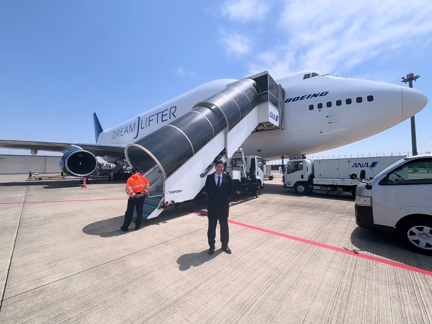 Crew beside boarding stairs at a Boeing Dreamlifter