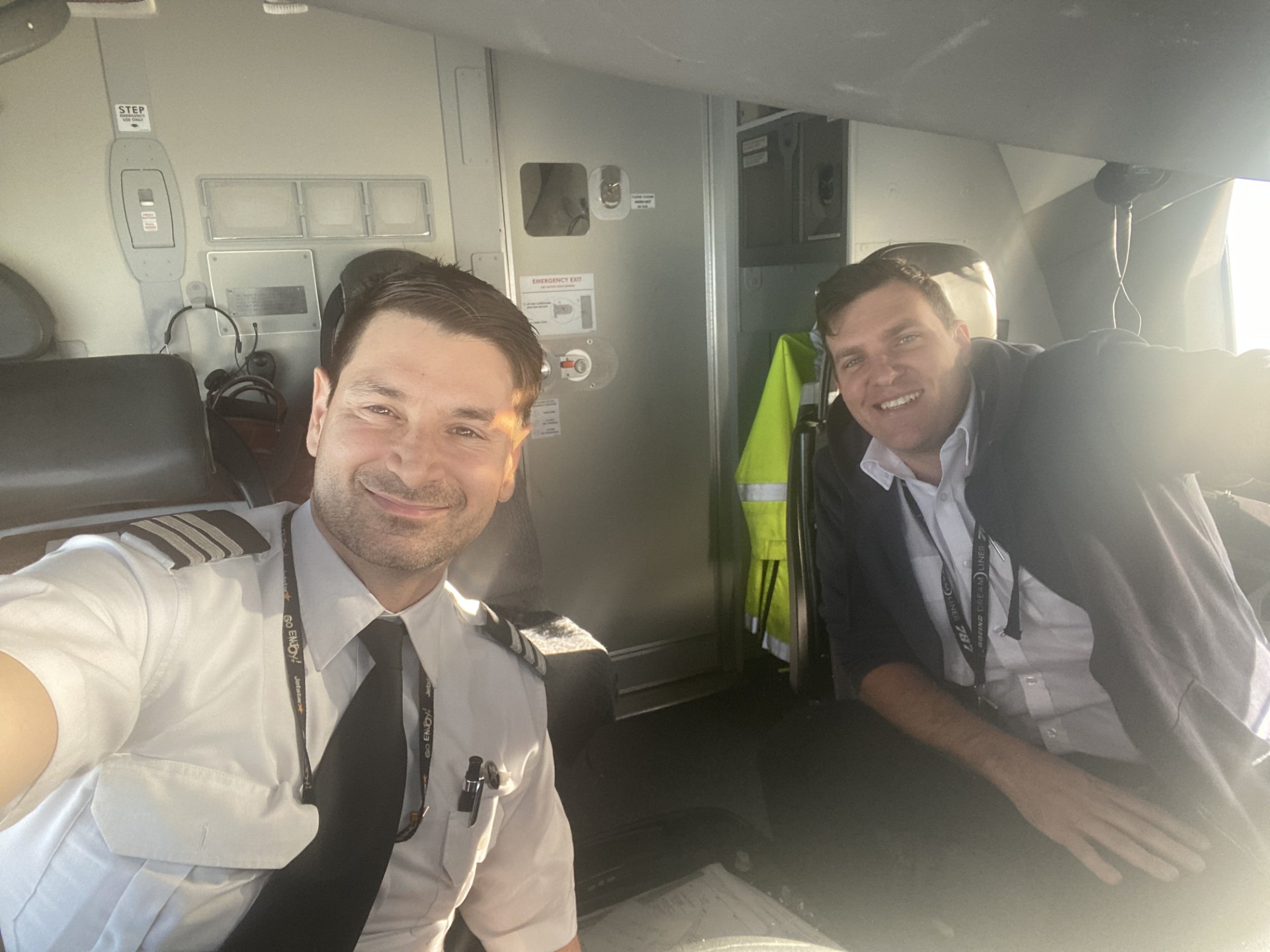 Two pilots sharing a sunny moment inside an aircraft