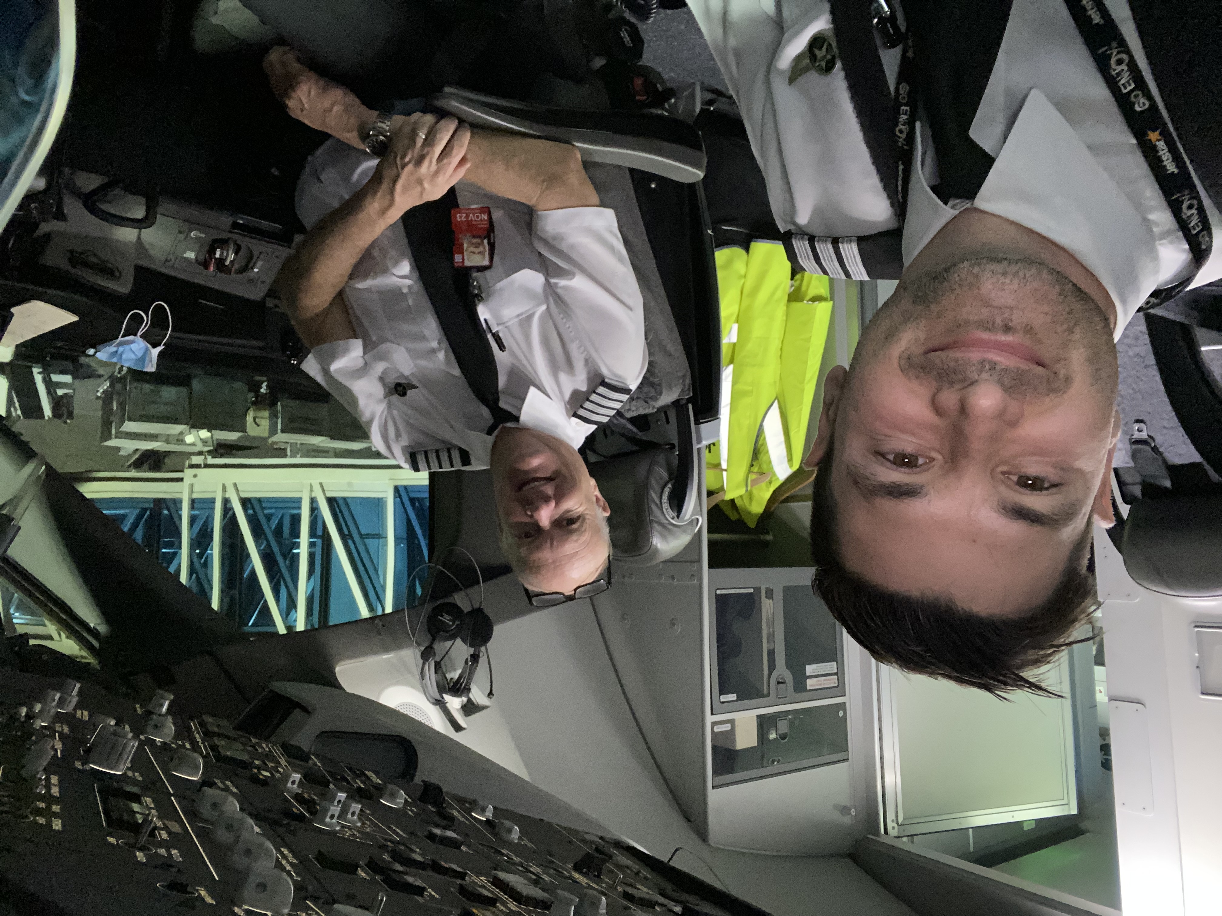 Two pilots sharing a moment on the flight deck at the gate