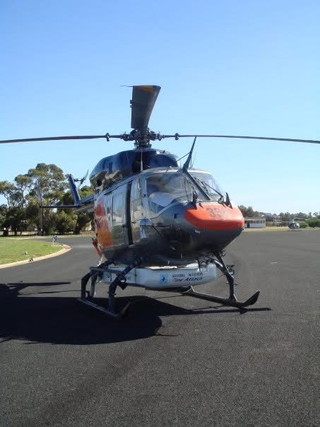 A helicopter seen nose-on on an airfield apron