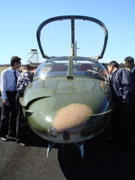 The nose and open canopy of a military jet on display