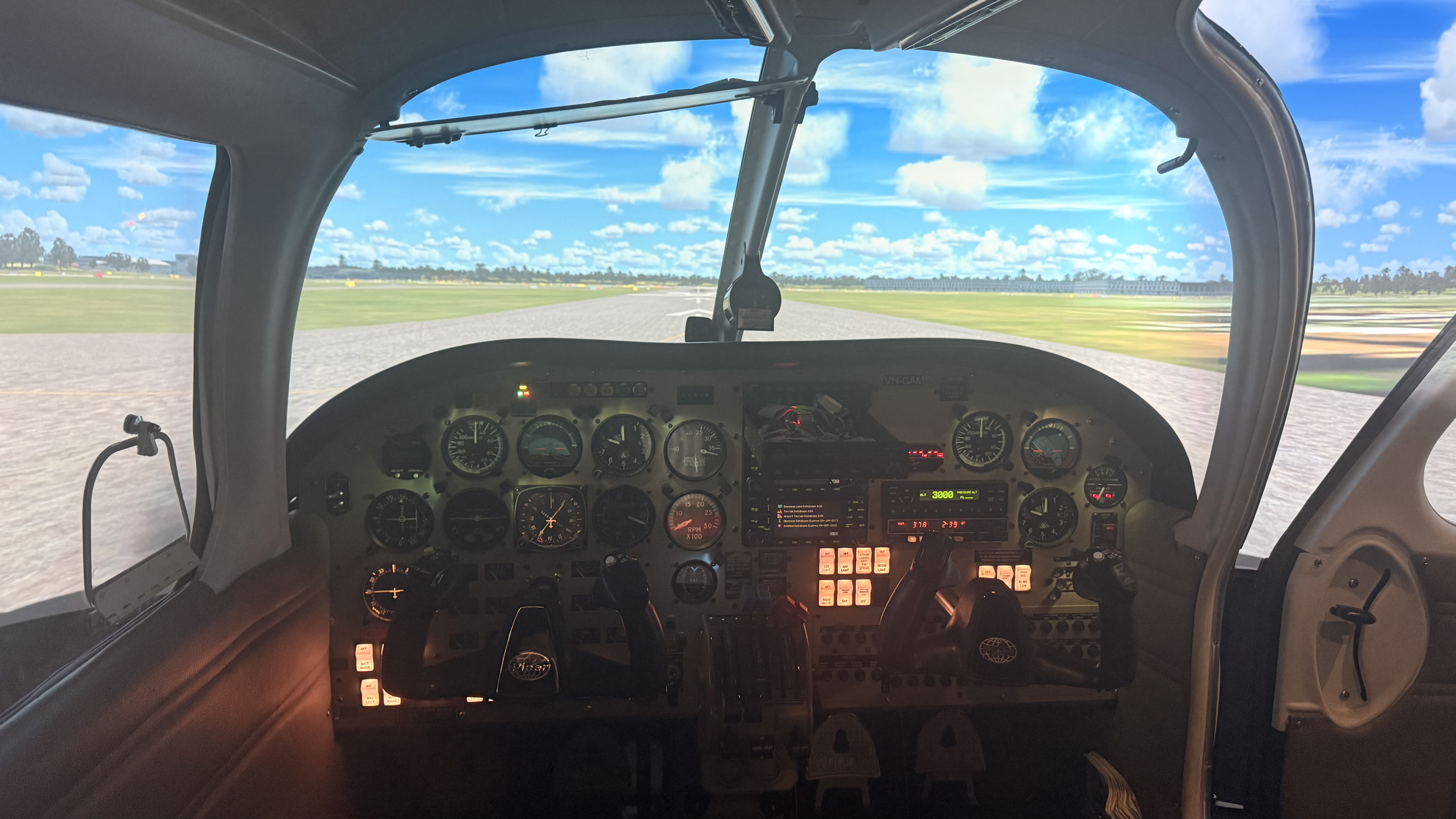 A light aircraft instrument panel and the sunny apron beyond its windscreen