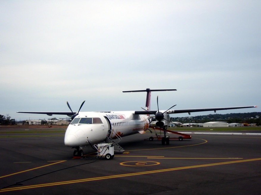 A QantasLink turboprop parked on the apron