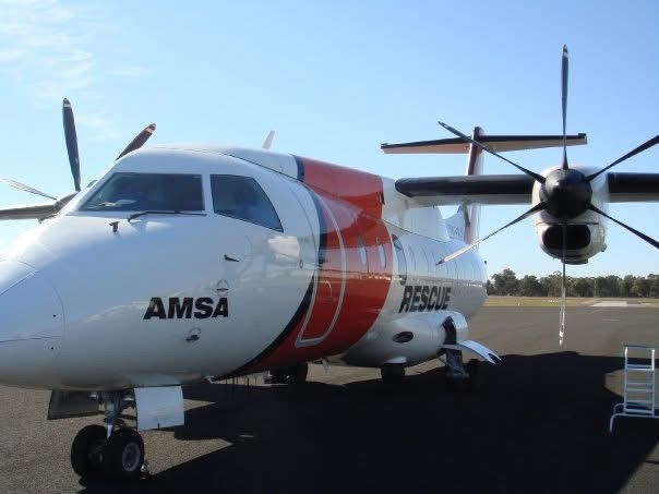 An AMSA rescue turboprop parked at an airfield