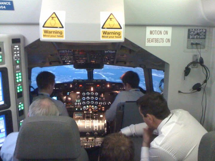 Pilots training together inside a flight simulator