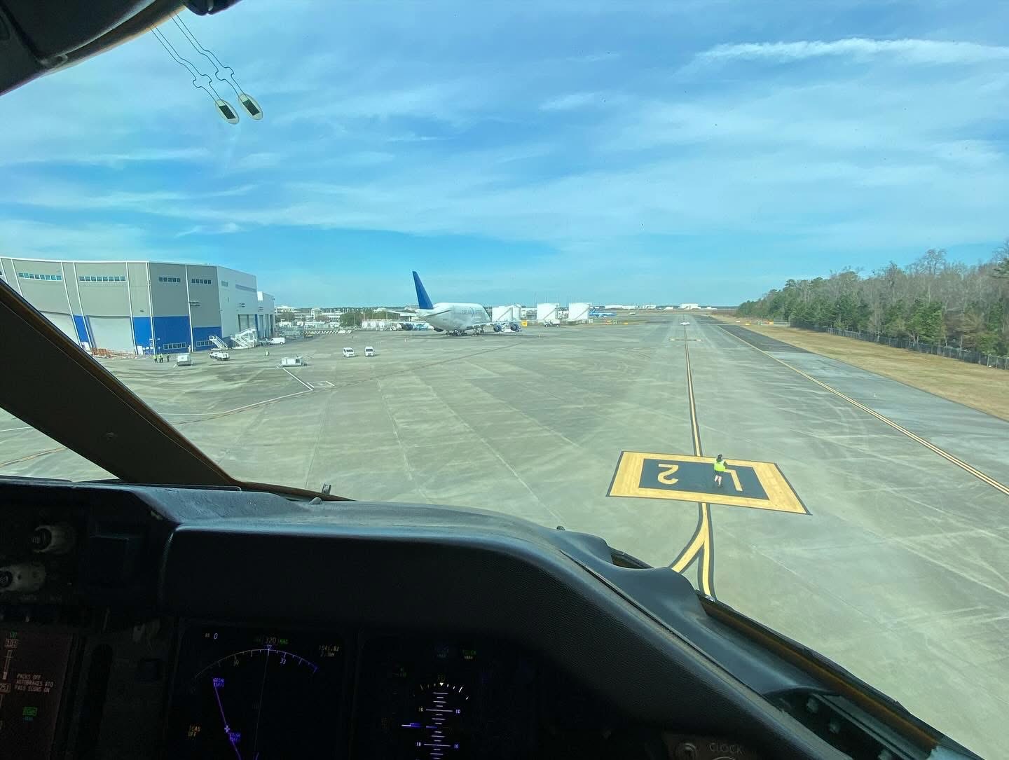 An airport taxiway seen through the flight-deck windscreen
