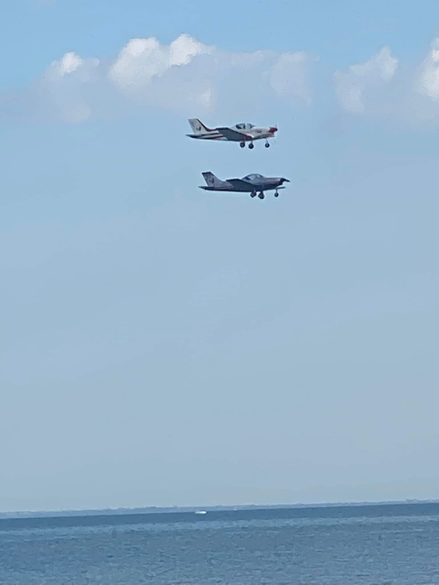 Two jets flying together above the sea