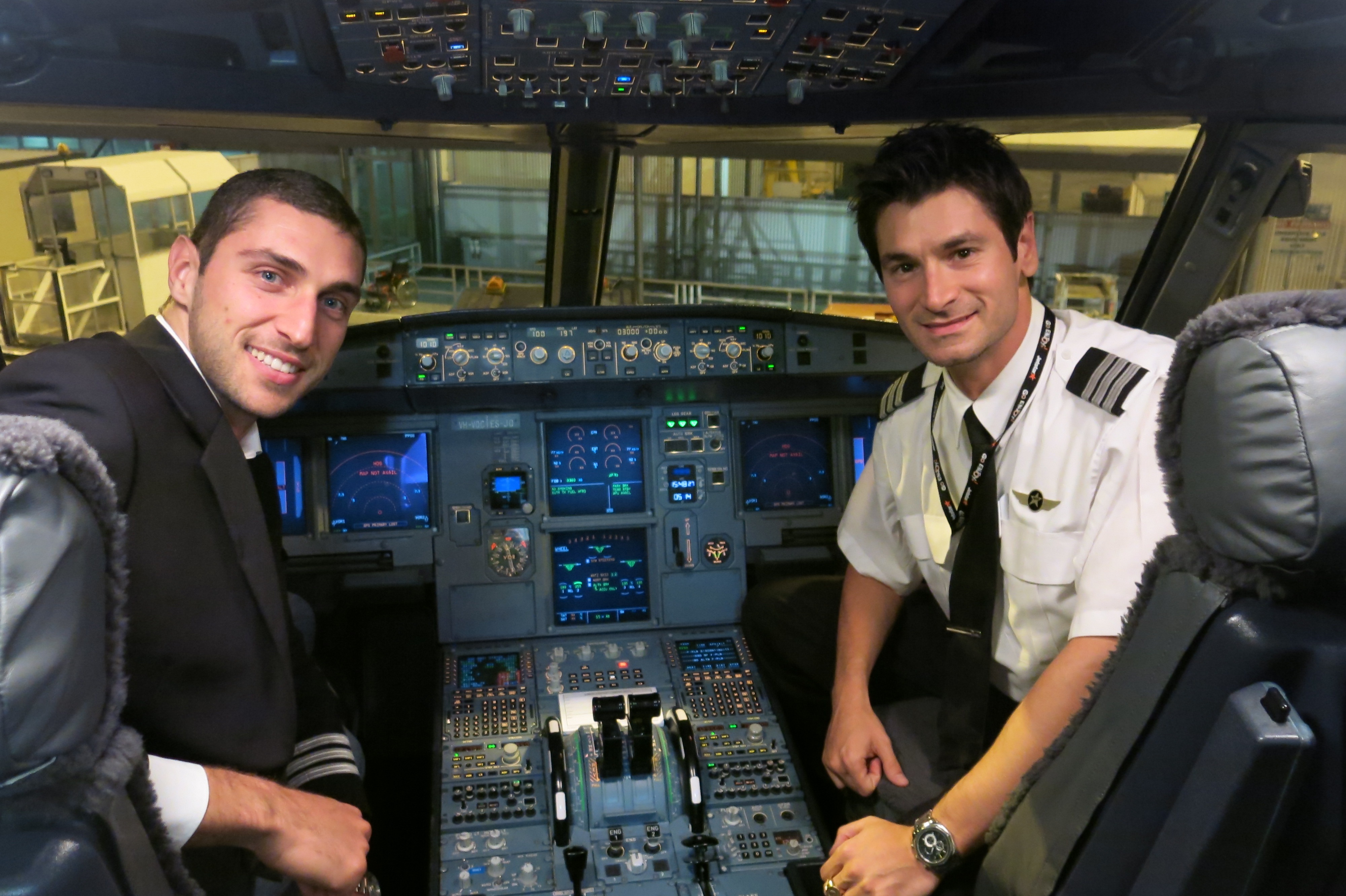 Two pilots seated together in an airliner cockpit